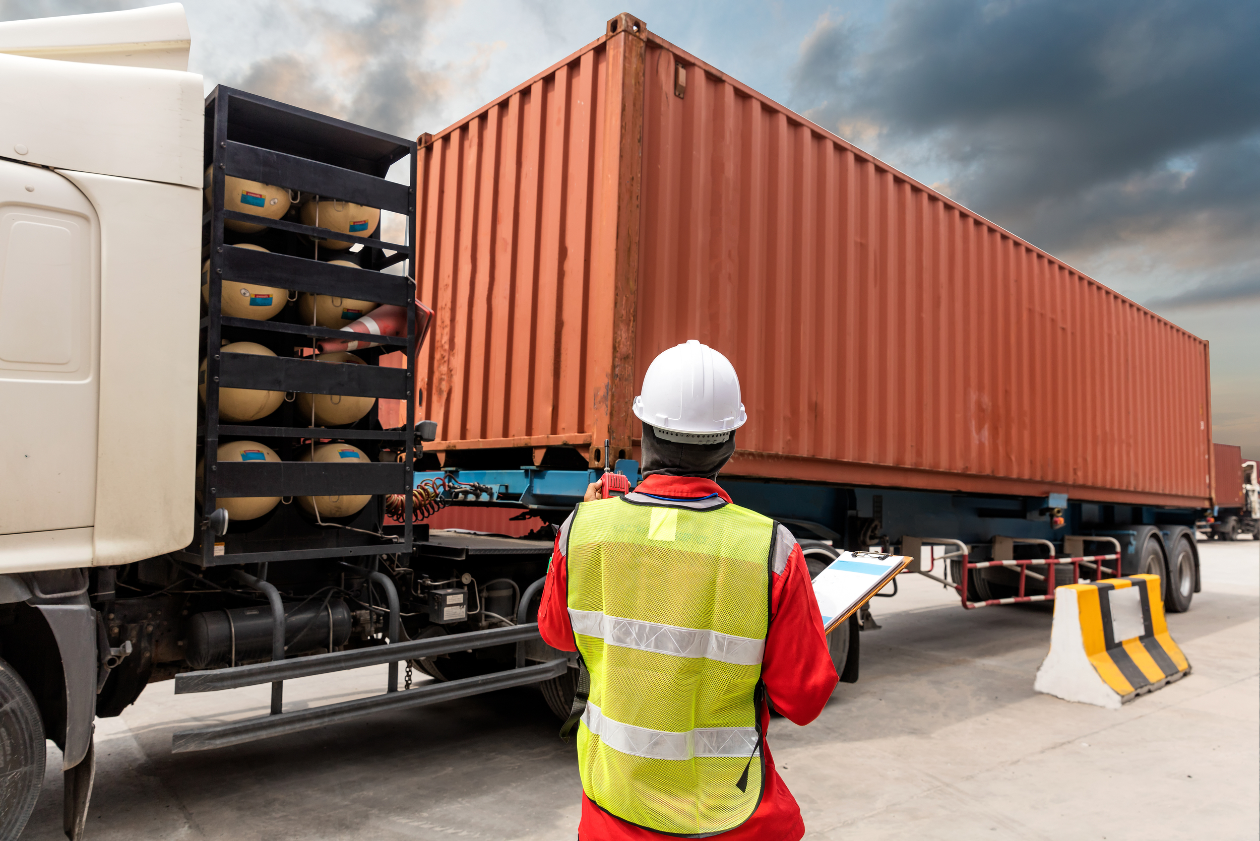 Worker inspecting a tractor trailer load.