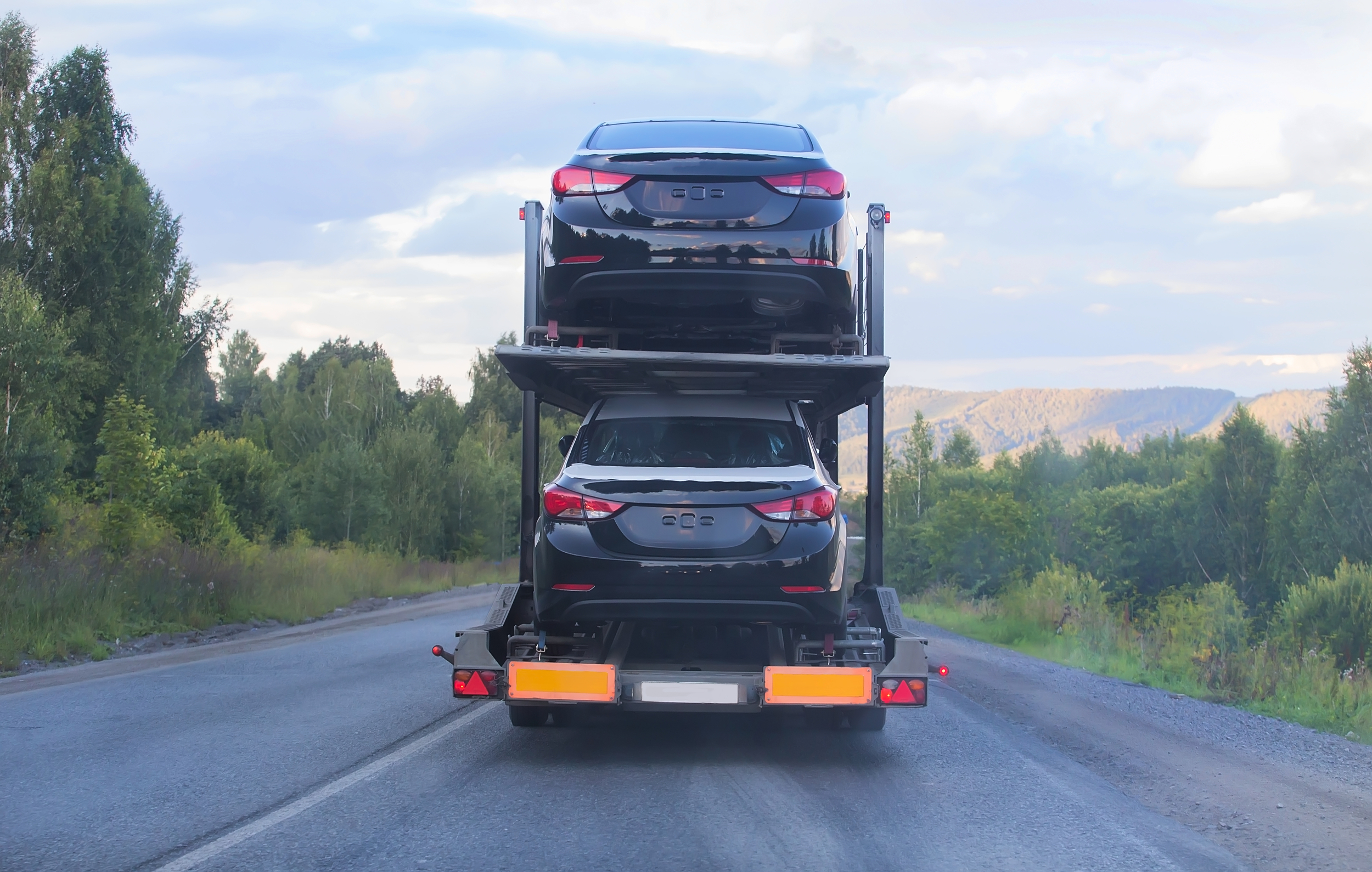 Rear view of a car hauler with 2 cars.